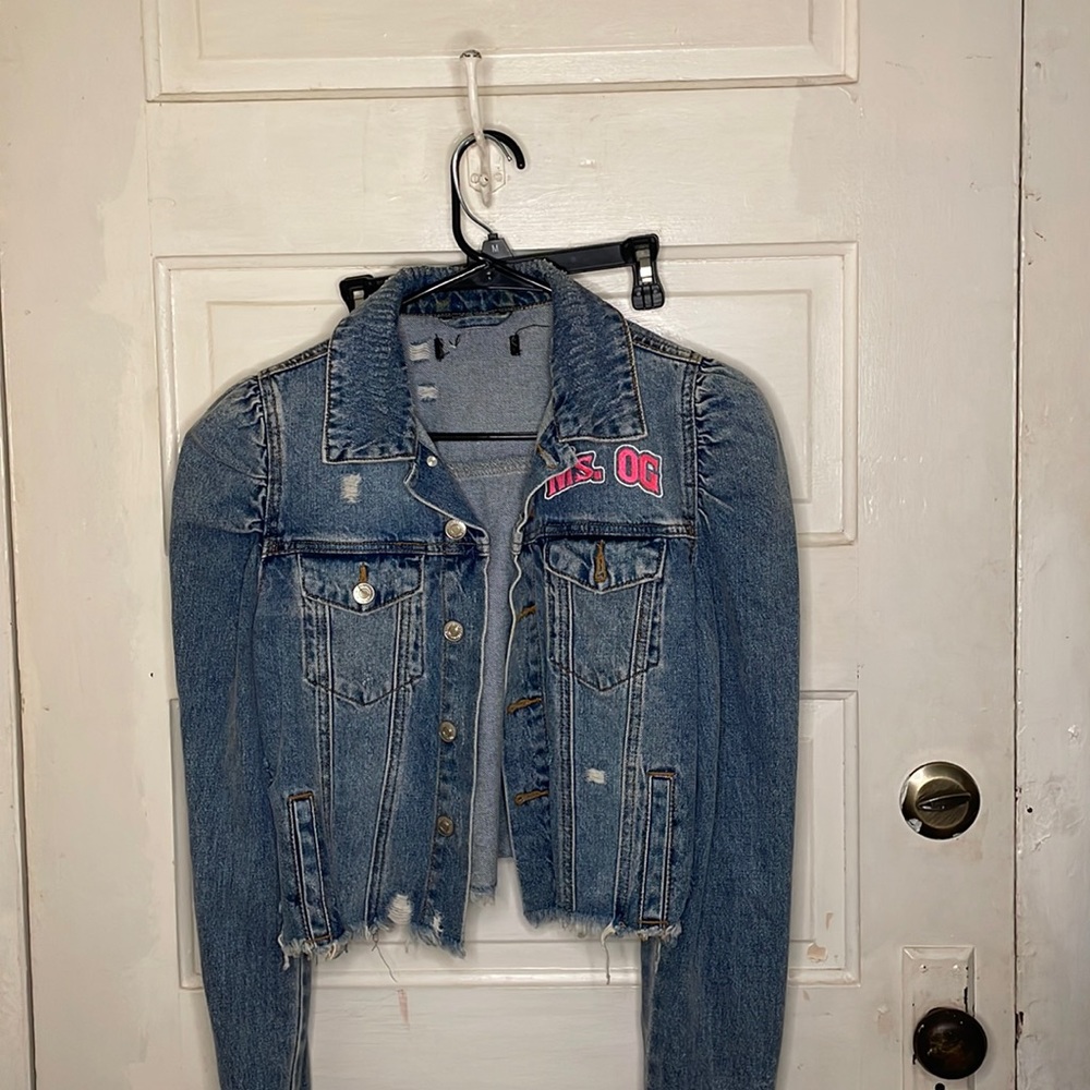 Custom “ms.og” cropped distressed denim jacket.
